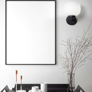 White wall light with black and white glass globe"